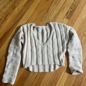 Cream colored V neck long sleeve knitted sweater. Large vertical ribs. HYFVE